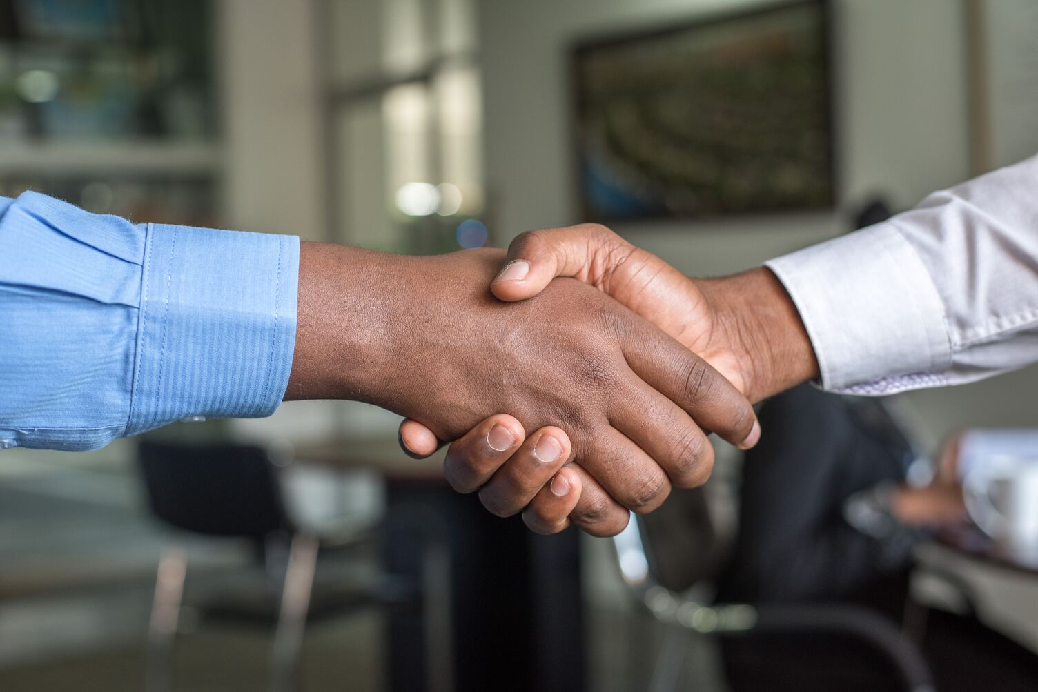 Business people shaking hands after a successfull sales pitch presentation