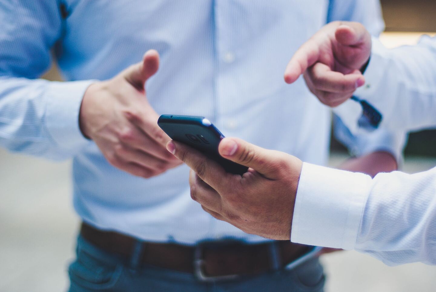 Real Estate Agents Looking At A Smartphone